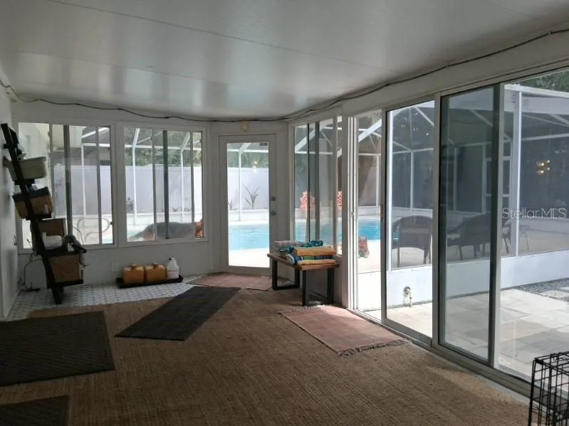 Florida Room has sliders to the backyard and a locked door to the screened pool and surround