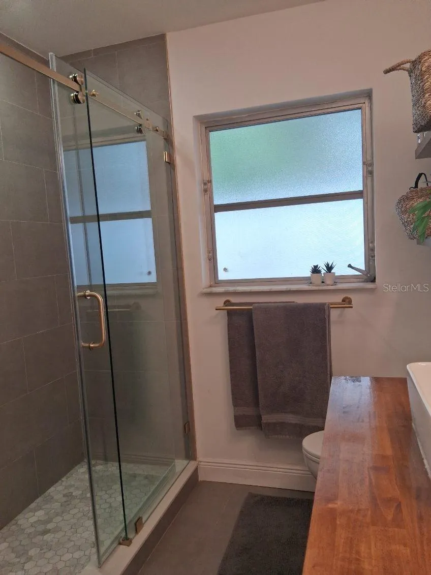 Newly remodeled shower with sliding glass doors