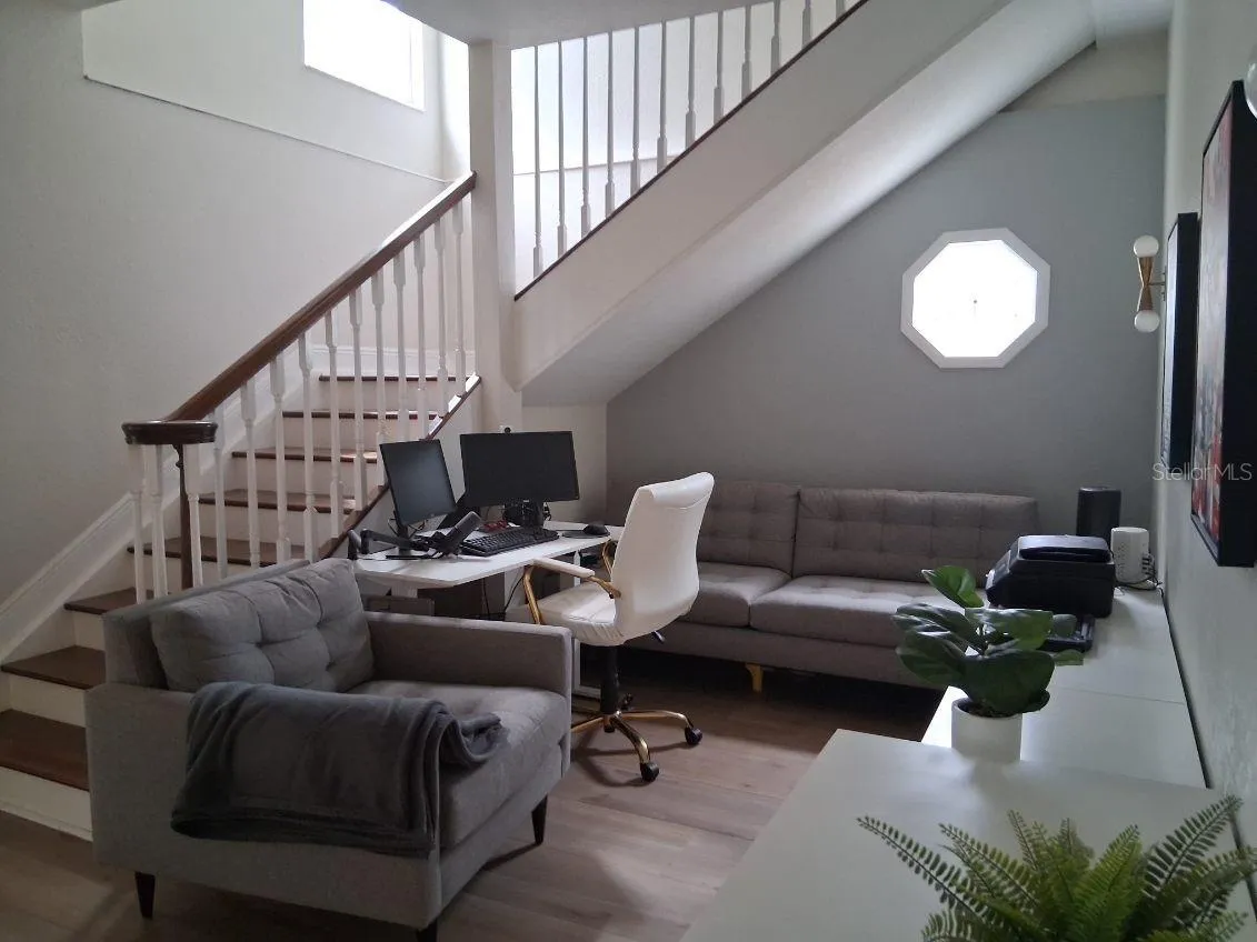Stairs to the second floor, and large flex space used as an Office
