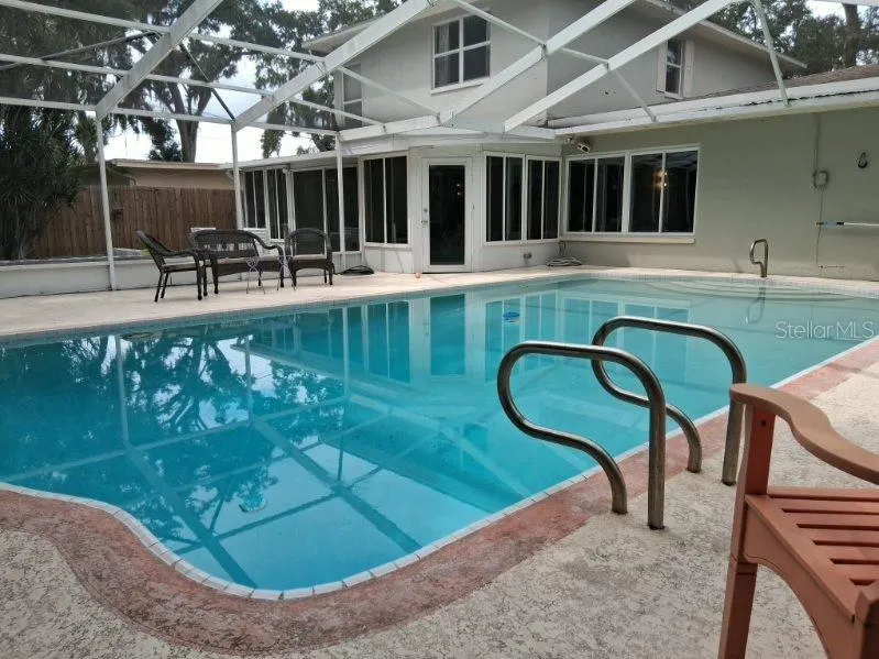 The pool surround is roomy enough for patio furniture, and is fully-screened
