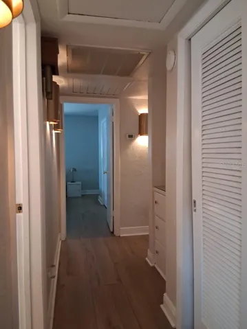 Downstairs hall with custom lighting and built-in cupboards for extra storage