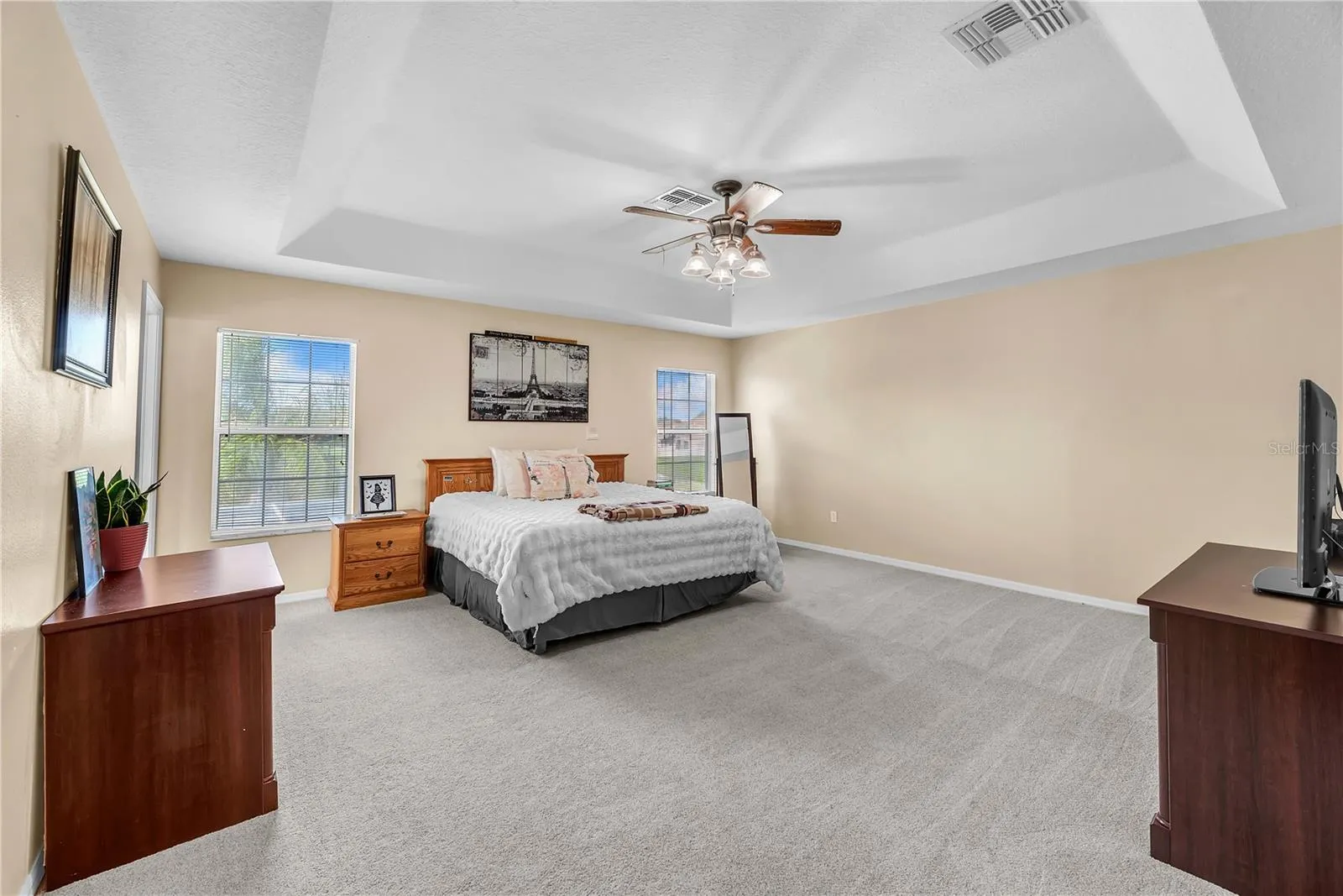 The spacious owner's suite has lots of natural light, a tray Ceiling detail and the Carpet was upgraded in 2021.