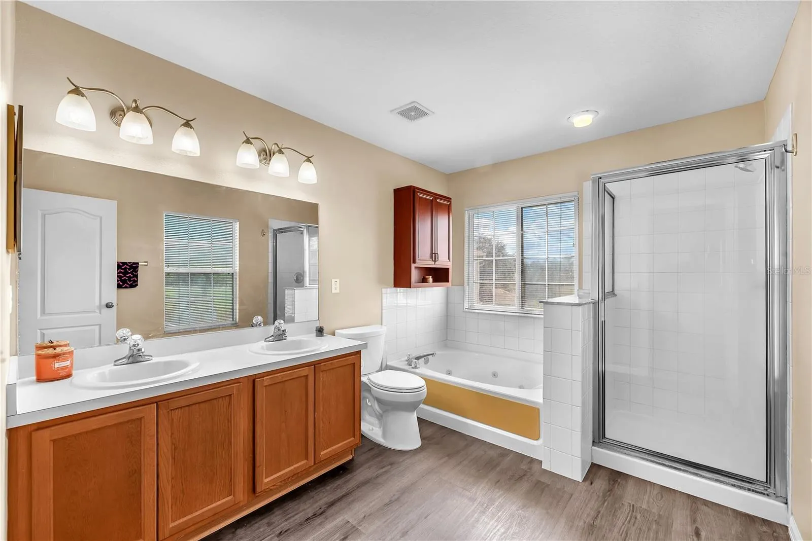 The primary bathroom offers a spa-inspired escape with a relaxing soaking tub, separate shower, and dual-sink vanity.