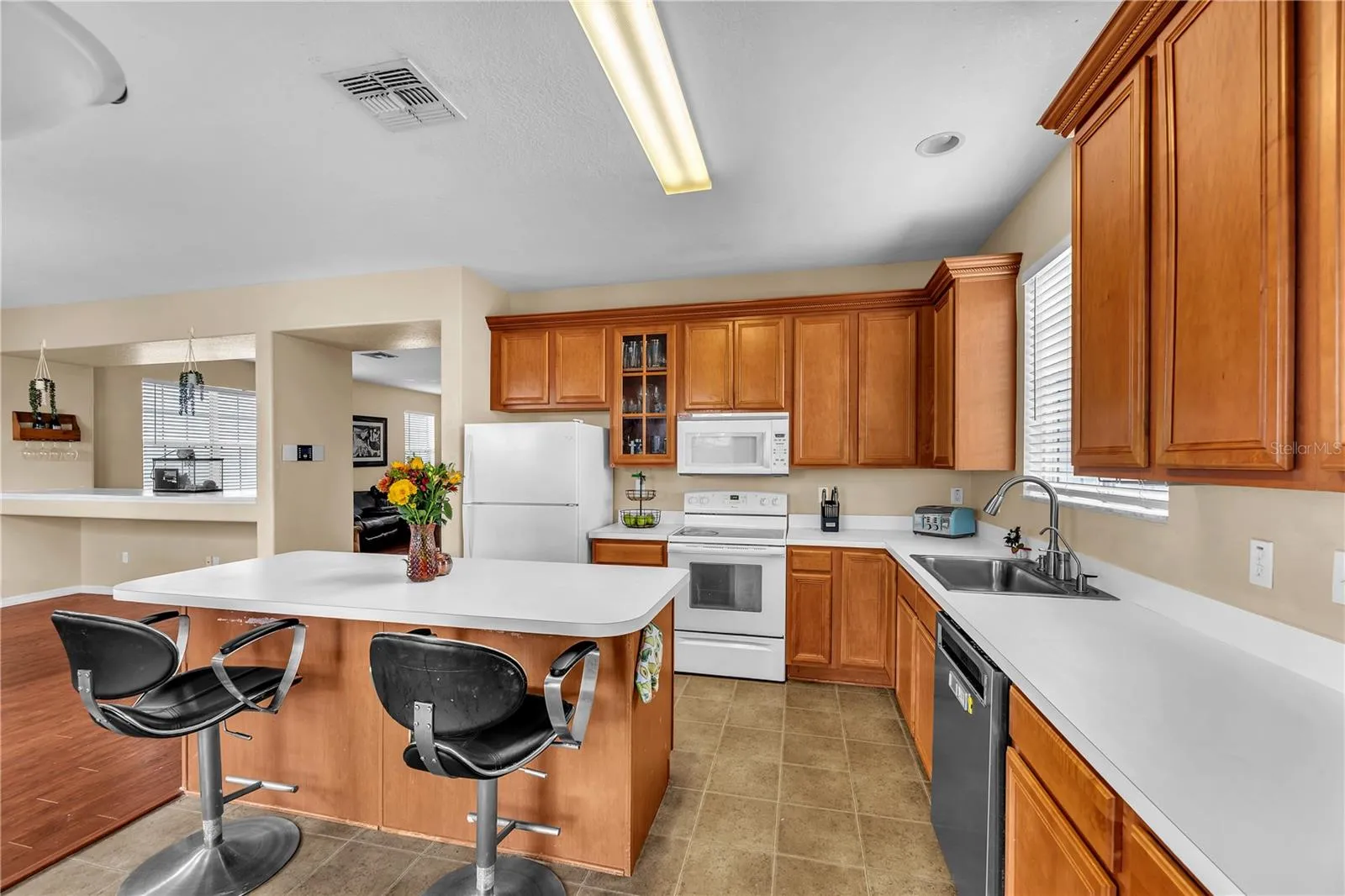 The thoughtfully designed kitchen offers an ideal blend of generous counter space, abundant storage, and a functional layout, making meal prep effortless and entertaining a pleasure.