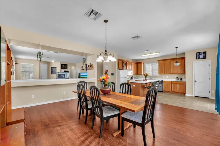 A spacious dining room sits just off the kitchen, with open sight lines into the living room that keep conversations flowing and create a warm, connected space for entertaining.