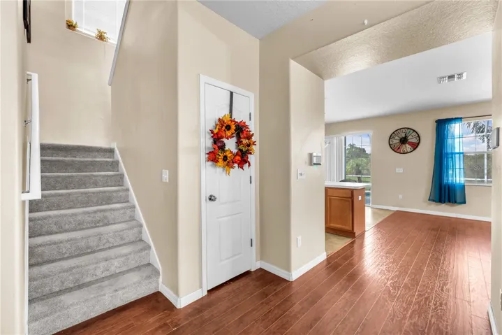 Understair storage leading upstairs to the large primary suite, bonus room, two additional bedrooms sharing a full bath and an oversized laundry room.