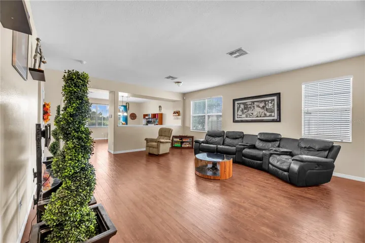 Durable wood-grain laminate flooring throughout the main living areas.