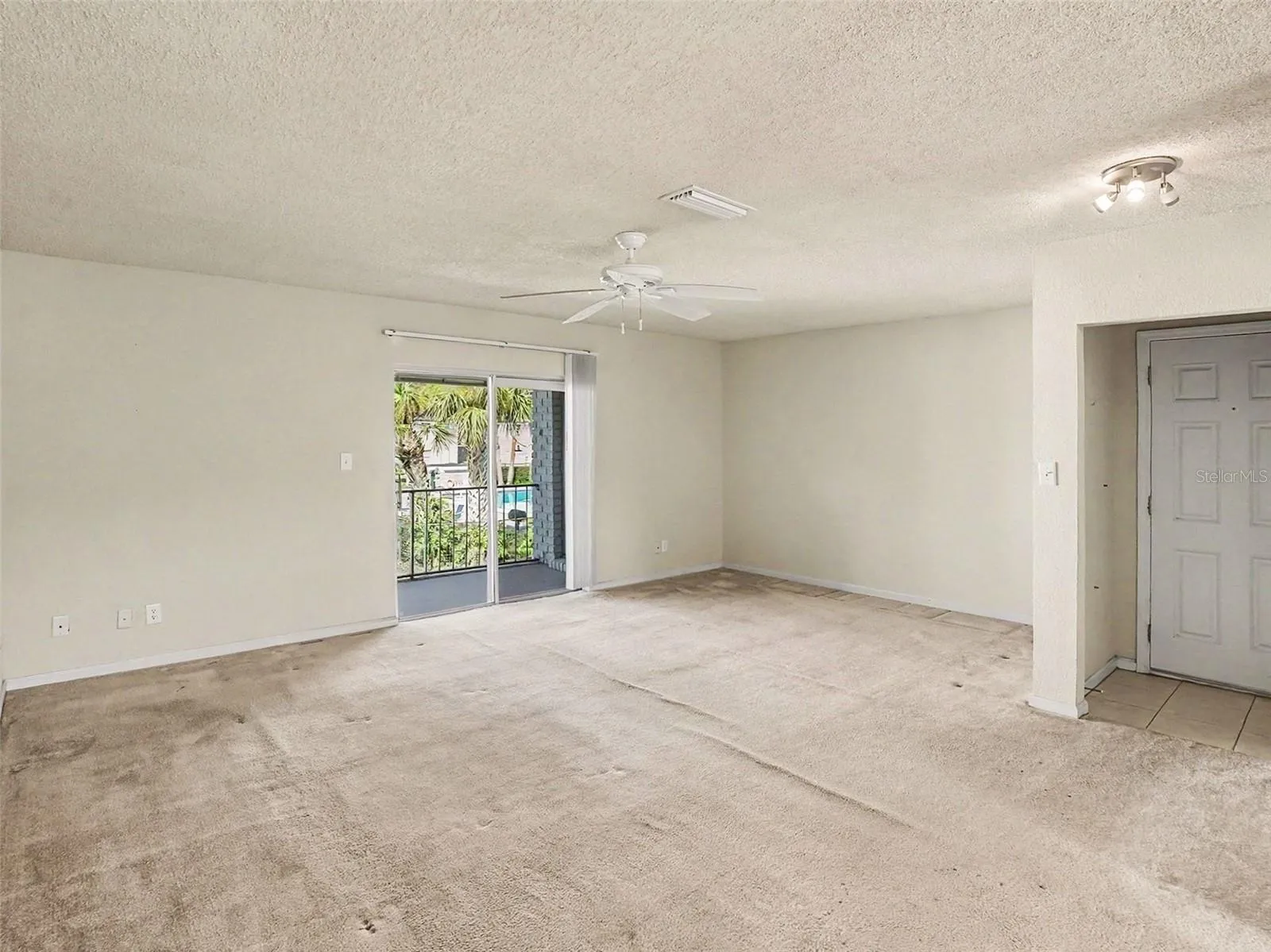Living Room Access to Balcony w/Storage Closet