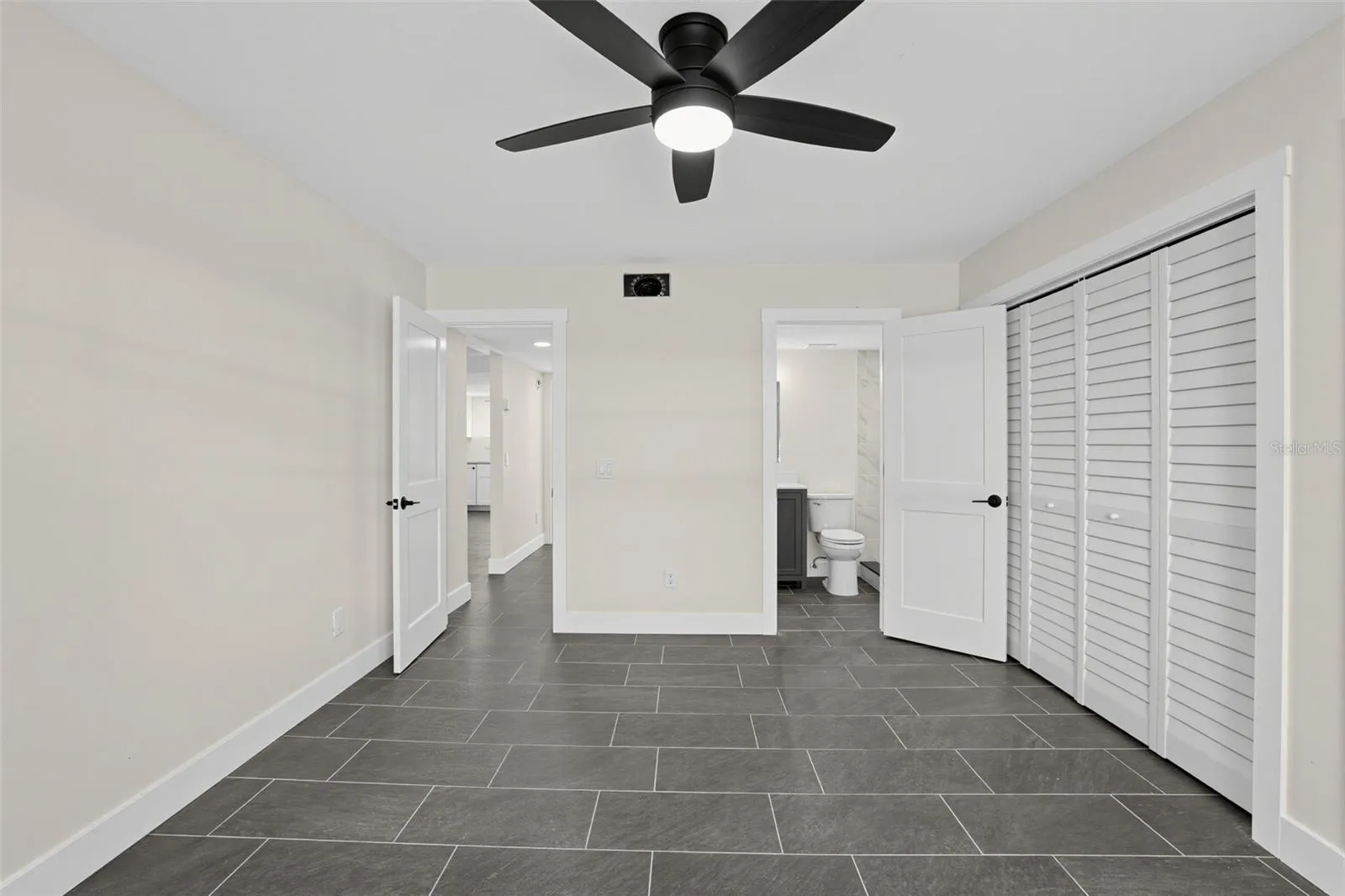 "Primary bedroom with ceiling fan"