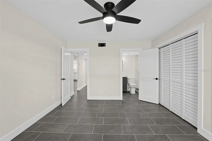 "Primary bedroom with ceiling fan"