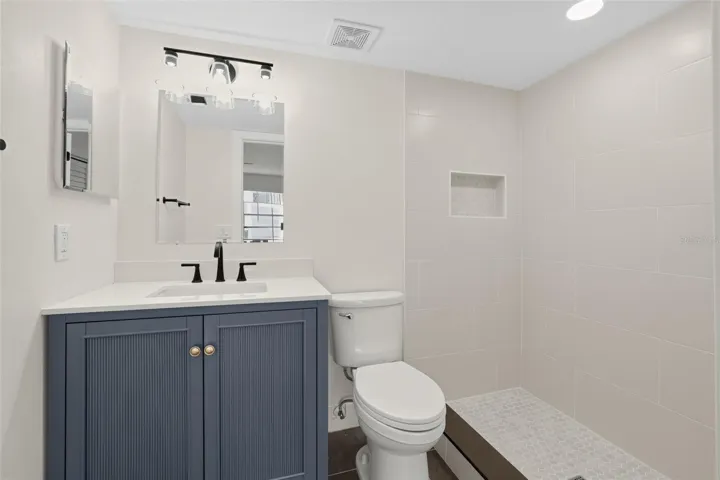 "Primary bath with tiled walk-in shower"