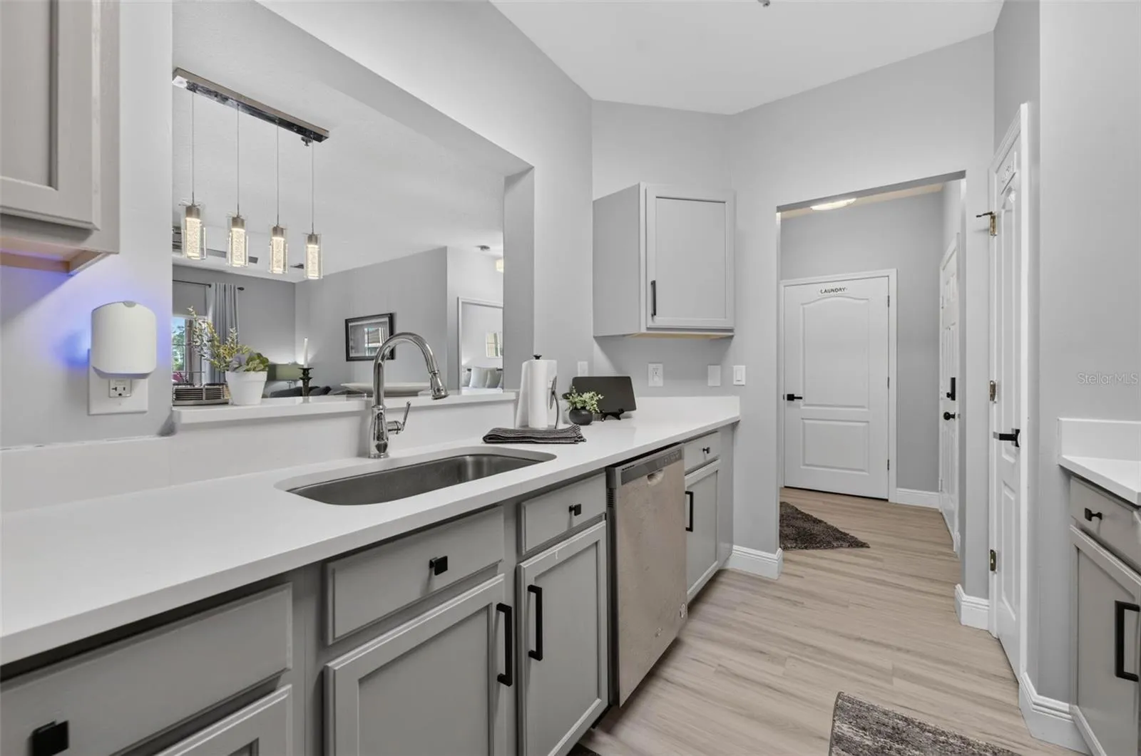 Kitchen sink and pendant lights over dining area