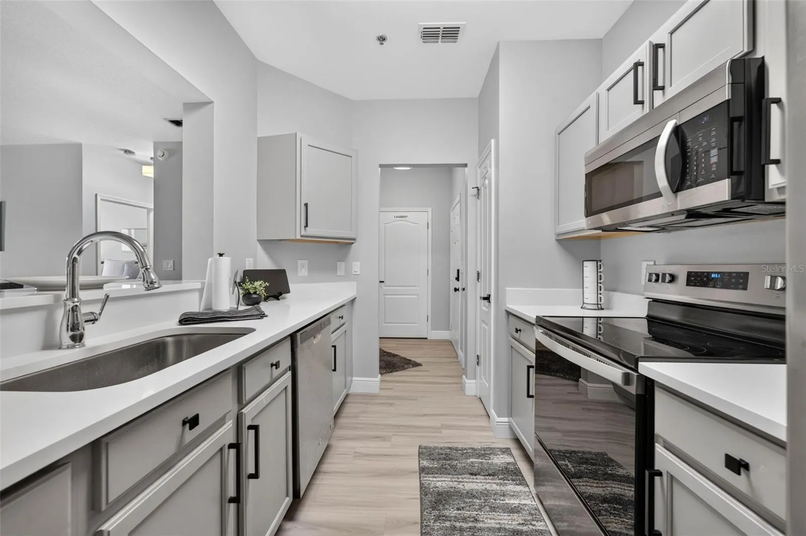 Kitchen sink with hallway beyond