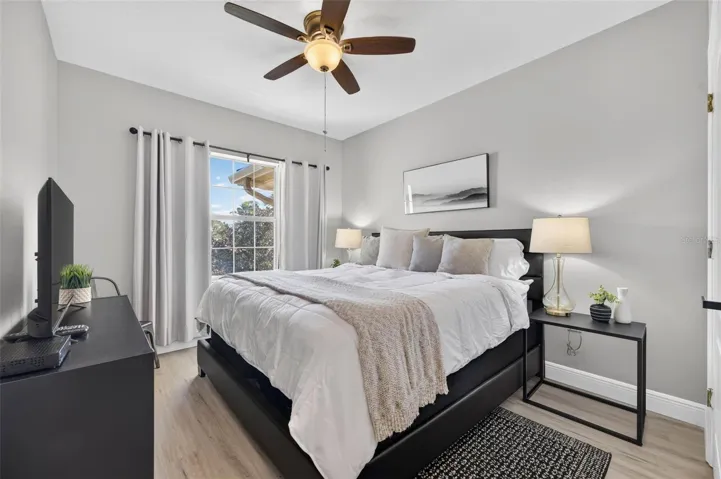 Second bedroom with ceiling fan and walk-in closet
