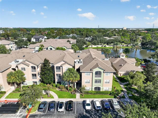 Aerial view of building and community pond