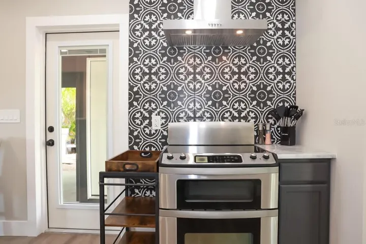 Range with hood and beautiful backsplash