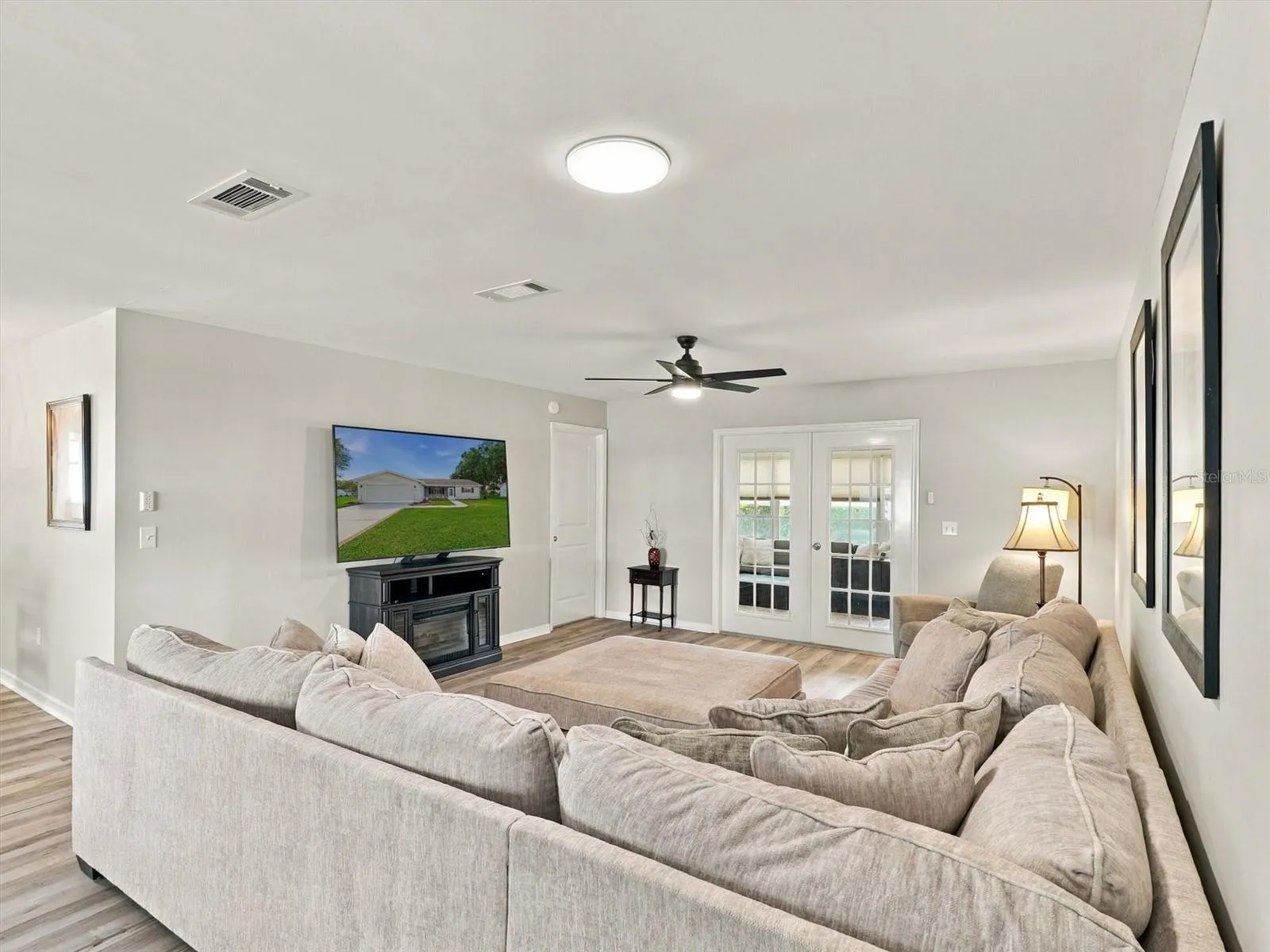 Living Room with Comfortable Sofa and 65" TV, Solar Tube