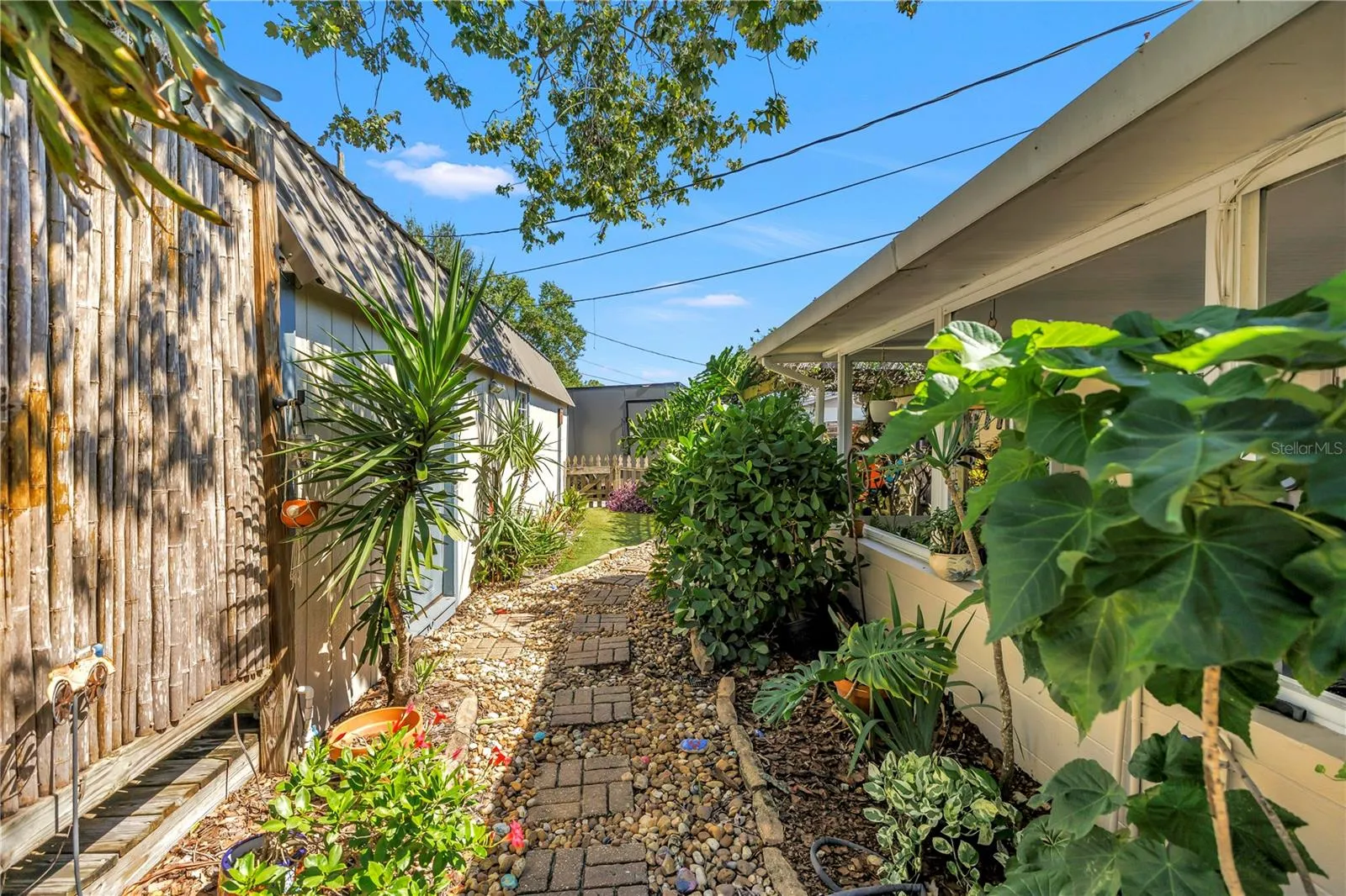 Garden path leading to workshop, gazebo and oversized secondary gated parking.