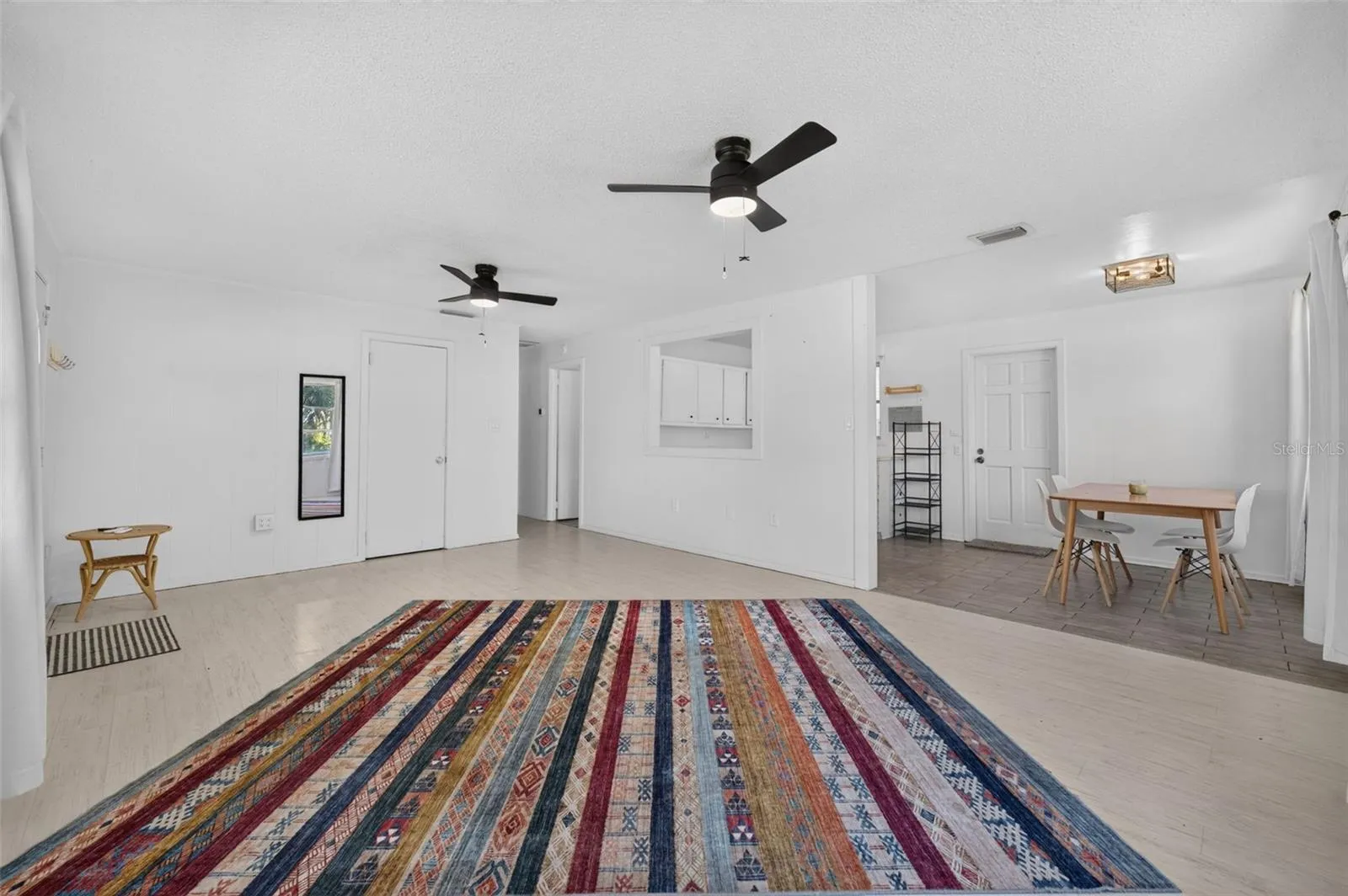 Living room with view of kitchen and dining space