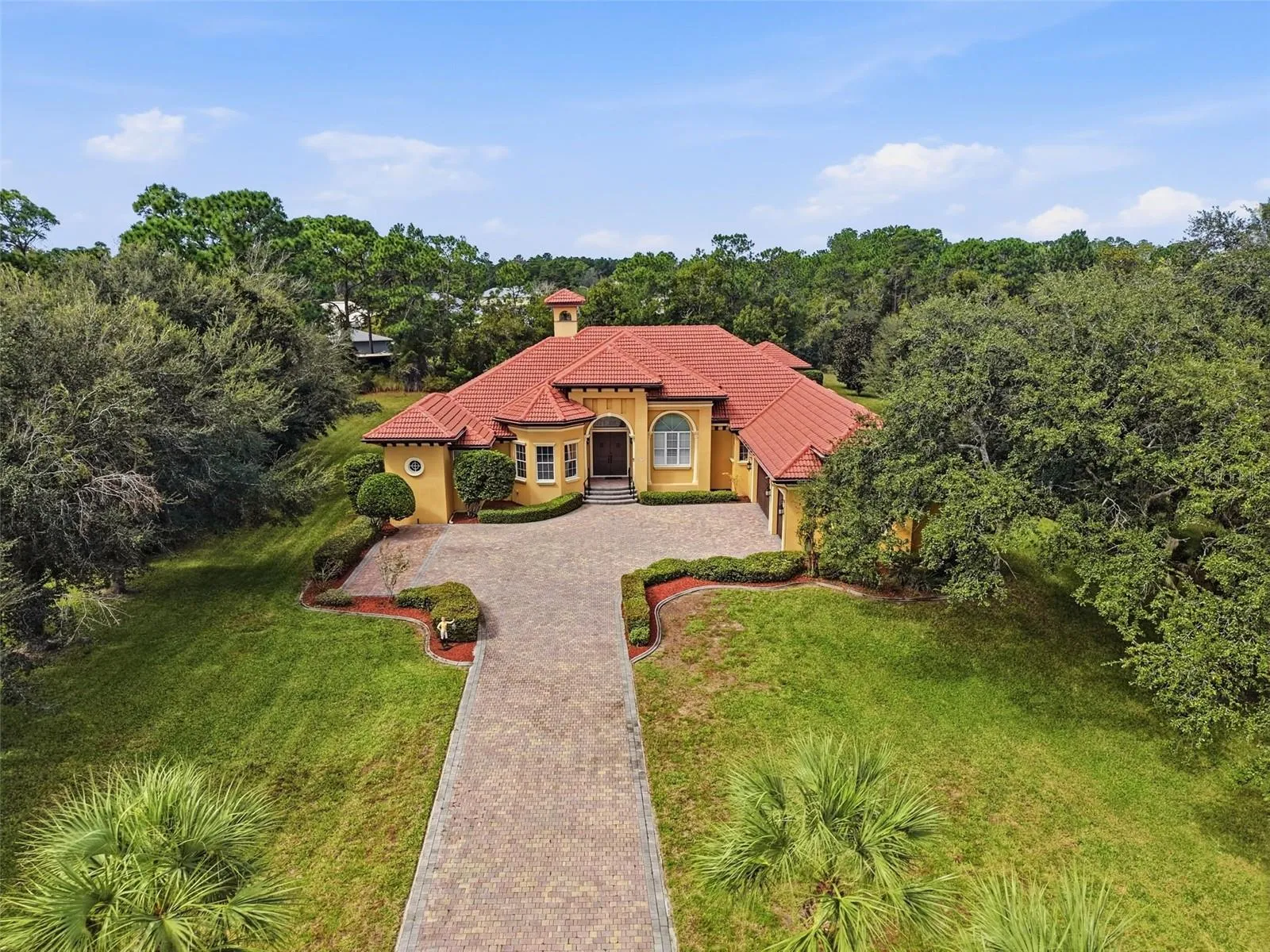 Gorgeous tile roof and long private paver driveway with gated entrance!