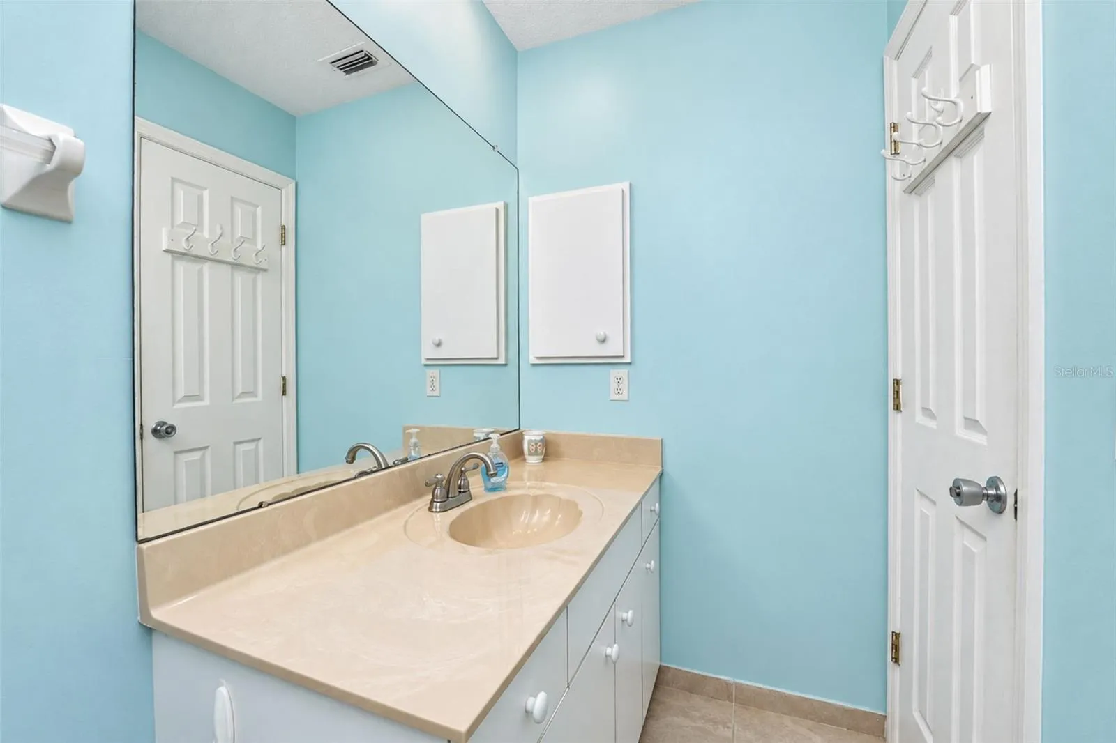 The guest bathroom vanity has a cultured marble countertop.