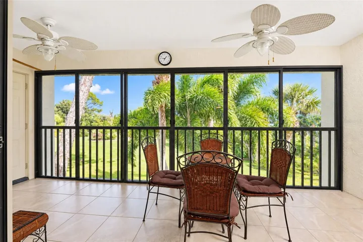 The vinyl enclosed lanai has tiled flooring and 2 ceiling fans.