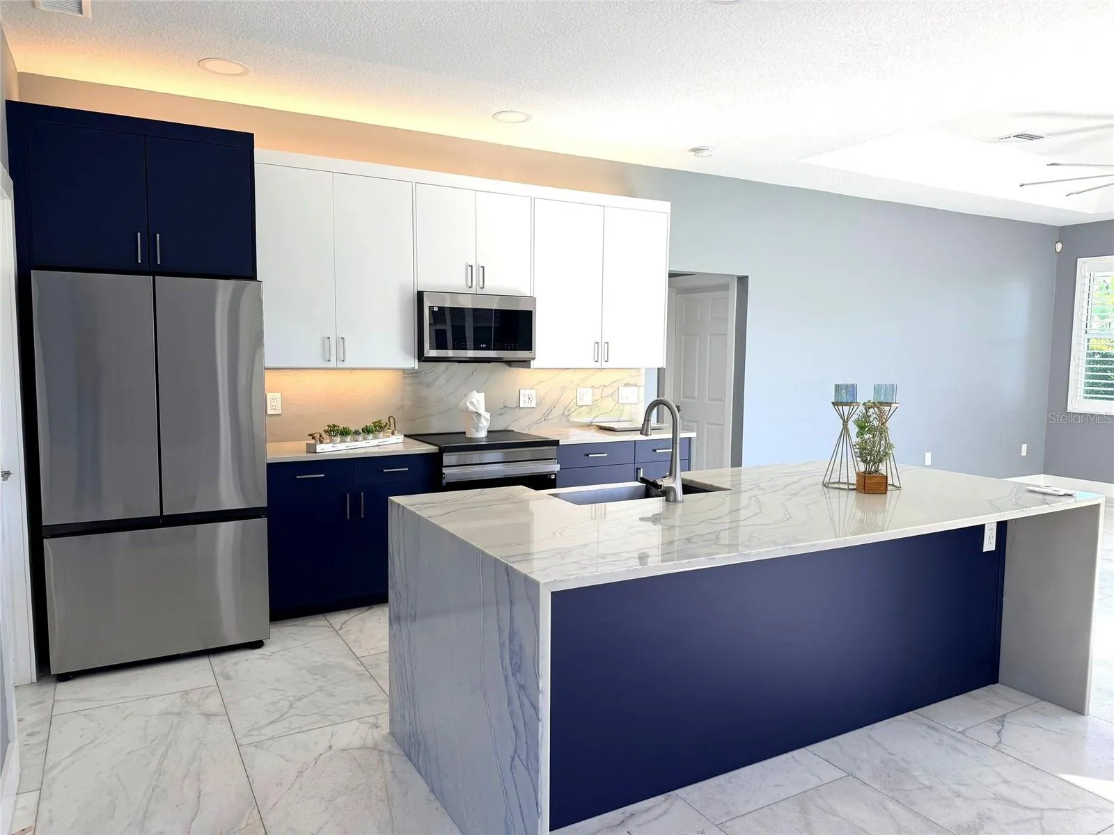 Kitchen View of Island and Refrigerator
