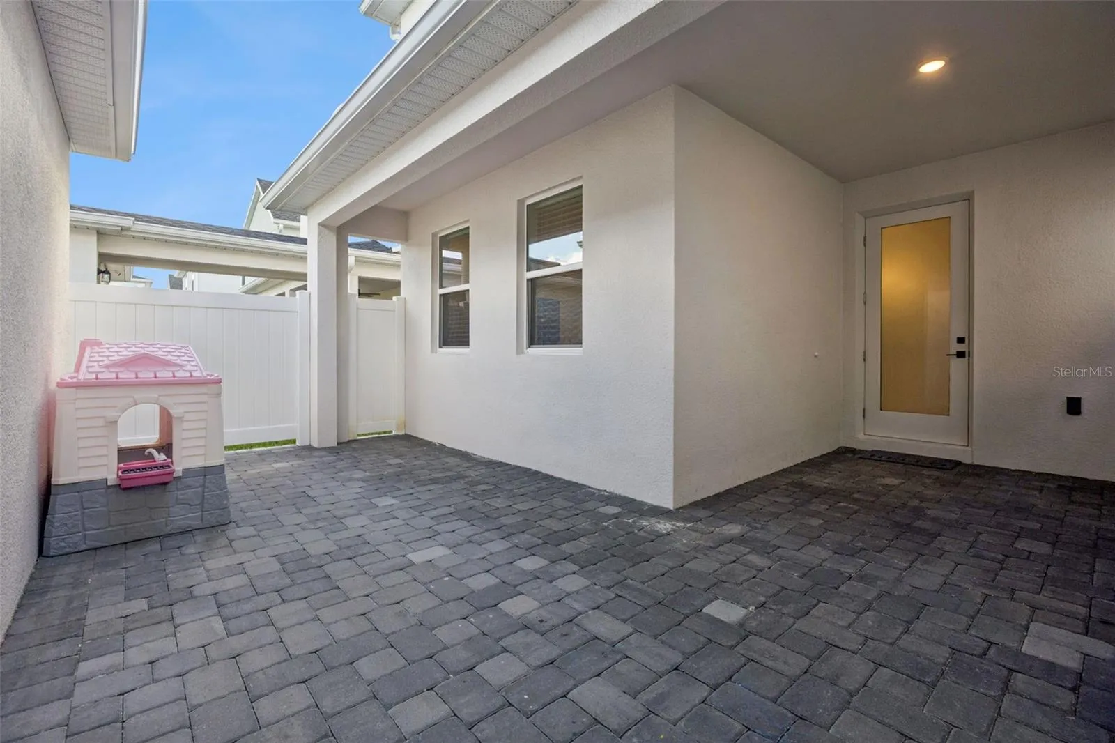 Courtyard between home and garage. There is a covered walkway from home to garage