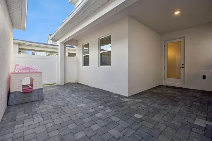 Courtyard between home and garage. There is a covered walkway from home to garage