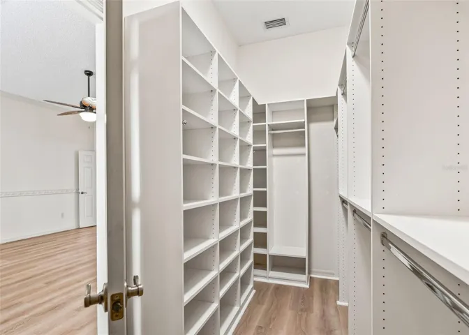 Primary Walk-In Closet w/ Organizers &amp; Solar Tube.