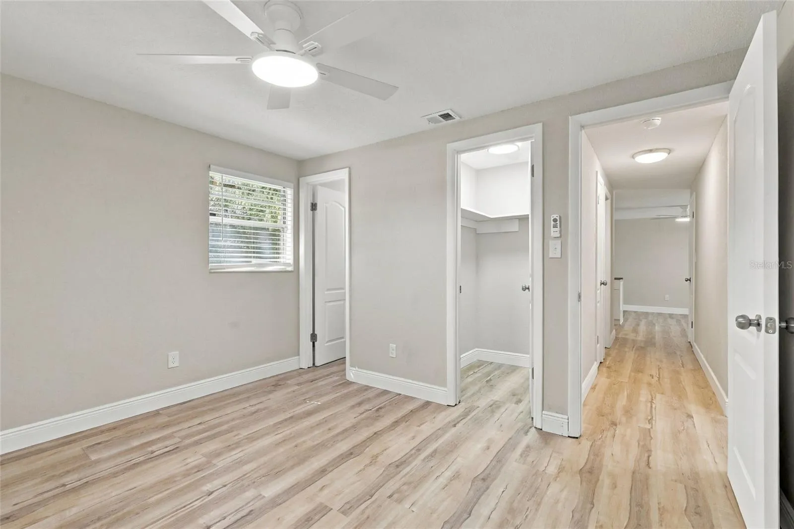 Primary bedroom with walk-in closet.