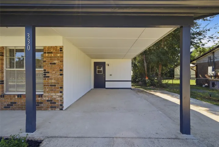 Carport with door to interior utility room.