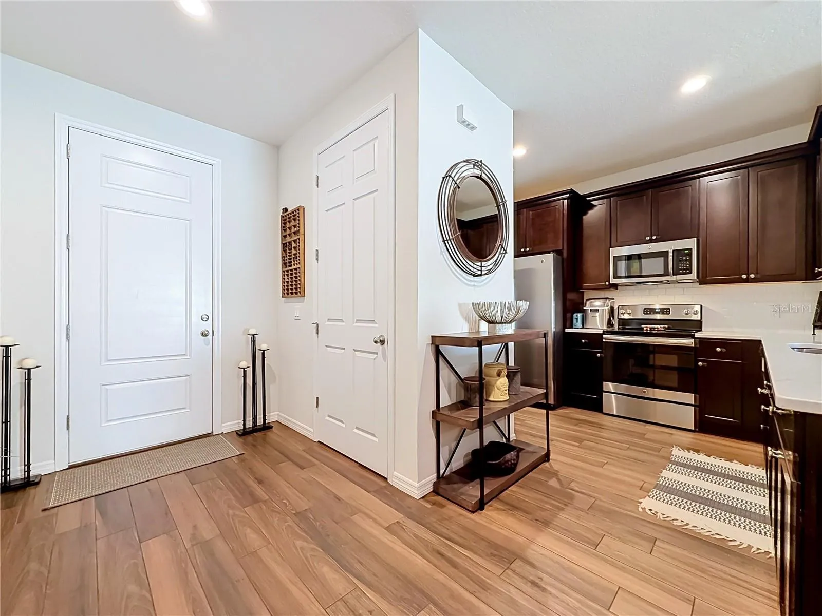 Step inside to discover a spacious OPEN FLOOR PLAN with soaring ceilings and beautiful WOOD-LOOK TILE flooring throughout the downstairs living areas.