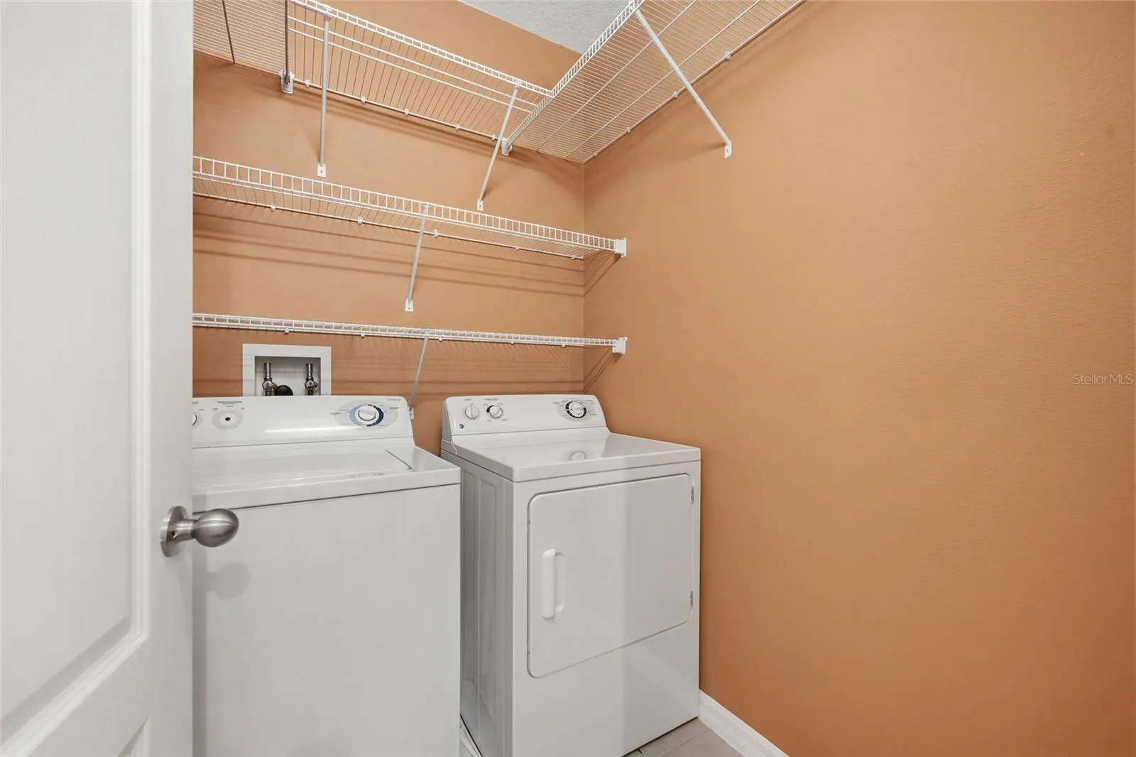 Laundry room featuring shelves