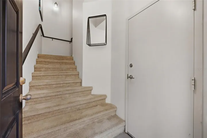 stairs leading up to living area.  Garage door coming into home