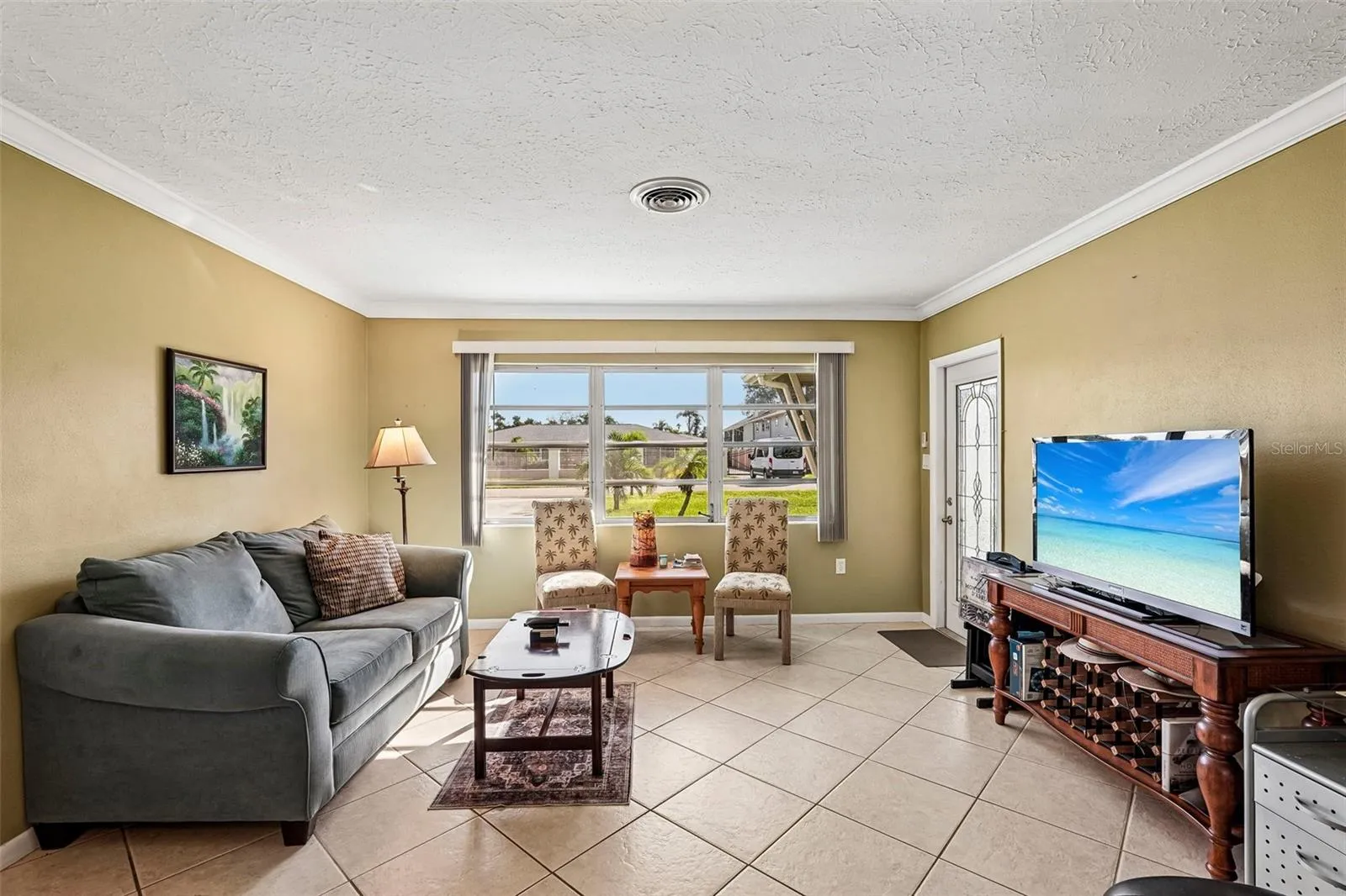 309 - open plan living room looking from kitchen, towards door to screened lanai.