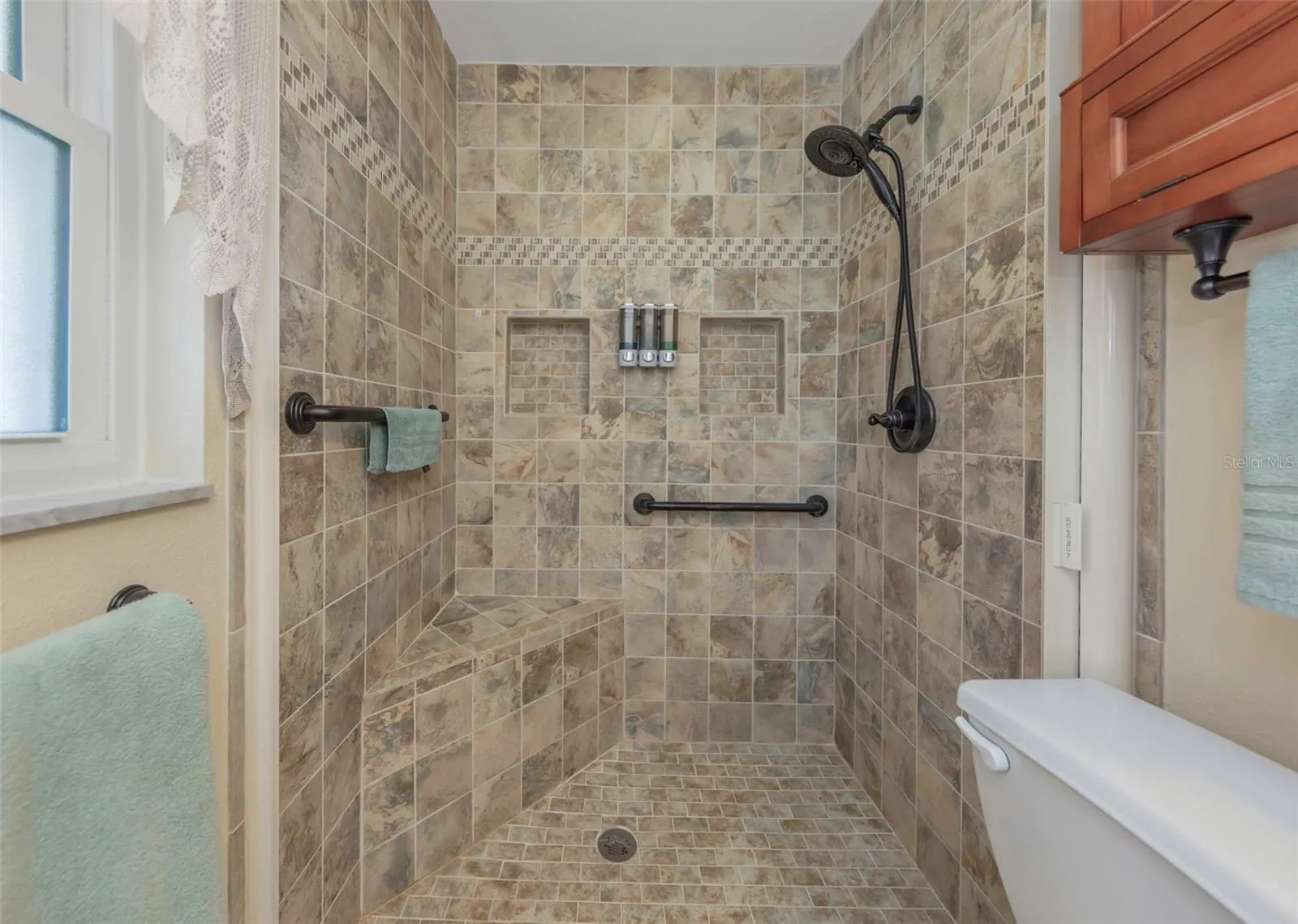 Oversized shower with built in seat.