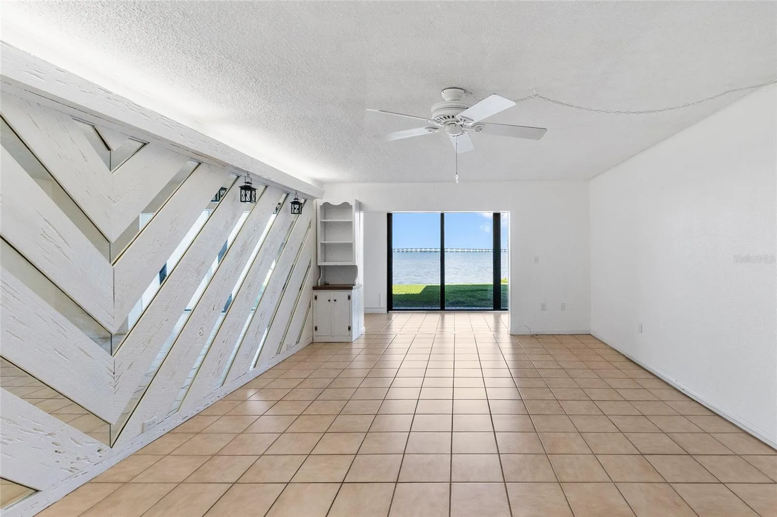 Living room looking directly towards sunroom and water view.