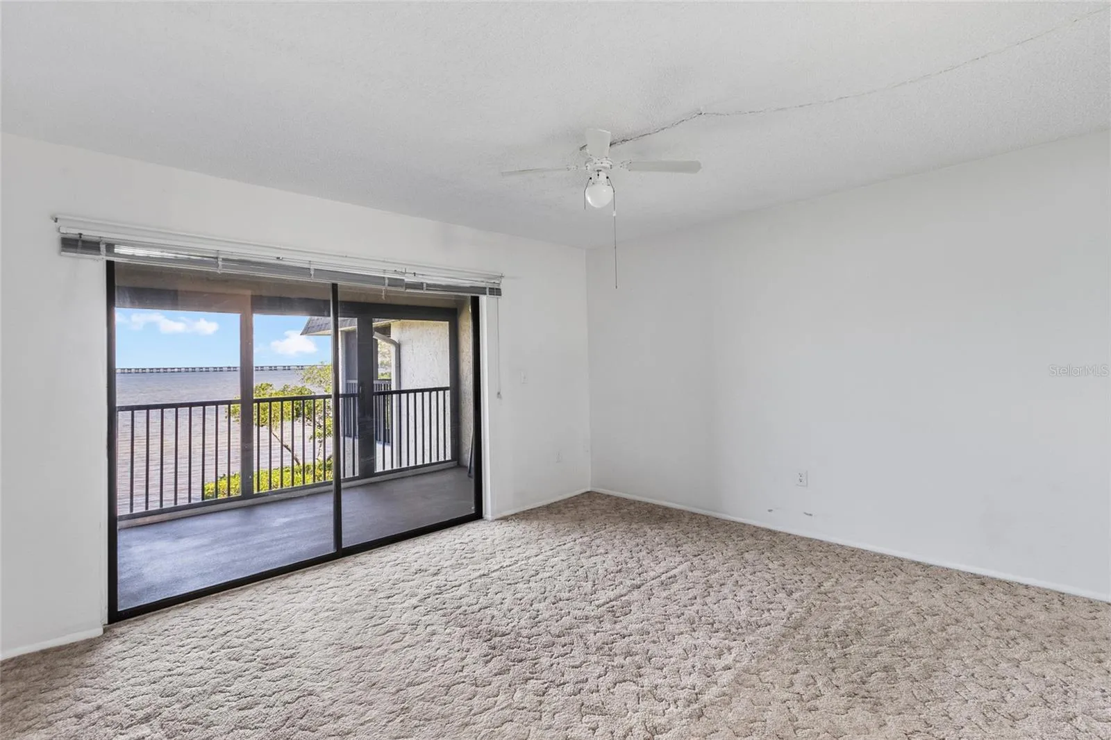 Primary bedroom over looking balcony with full panoramic water views.