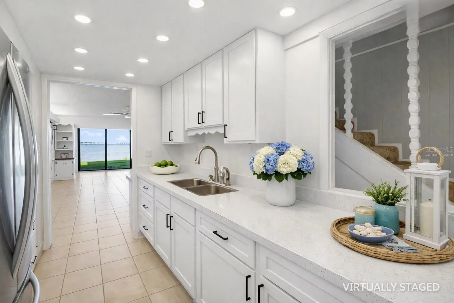 Virtually staged kitchem -to help envision recessed lighting, quart counter tops and white cabinets
