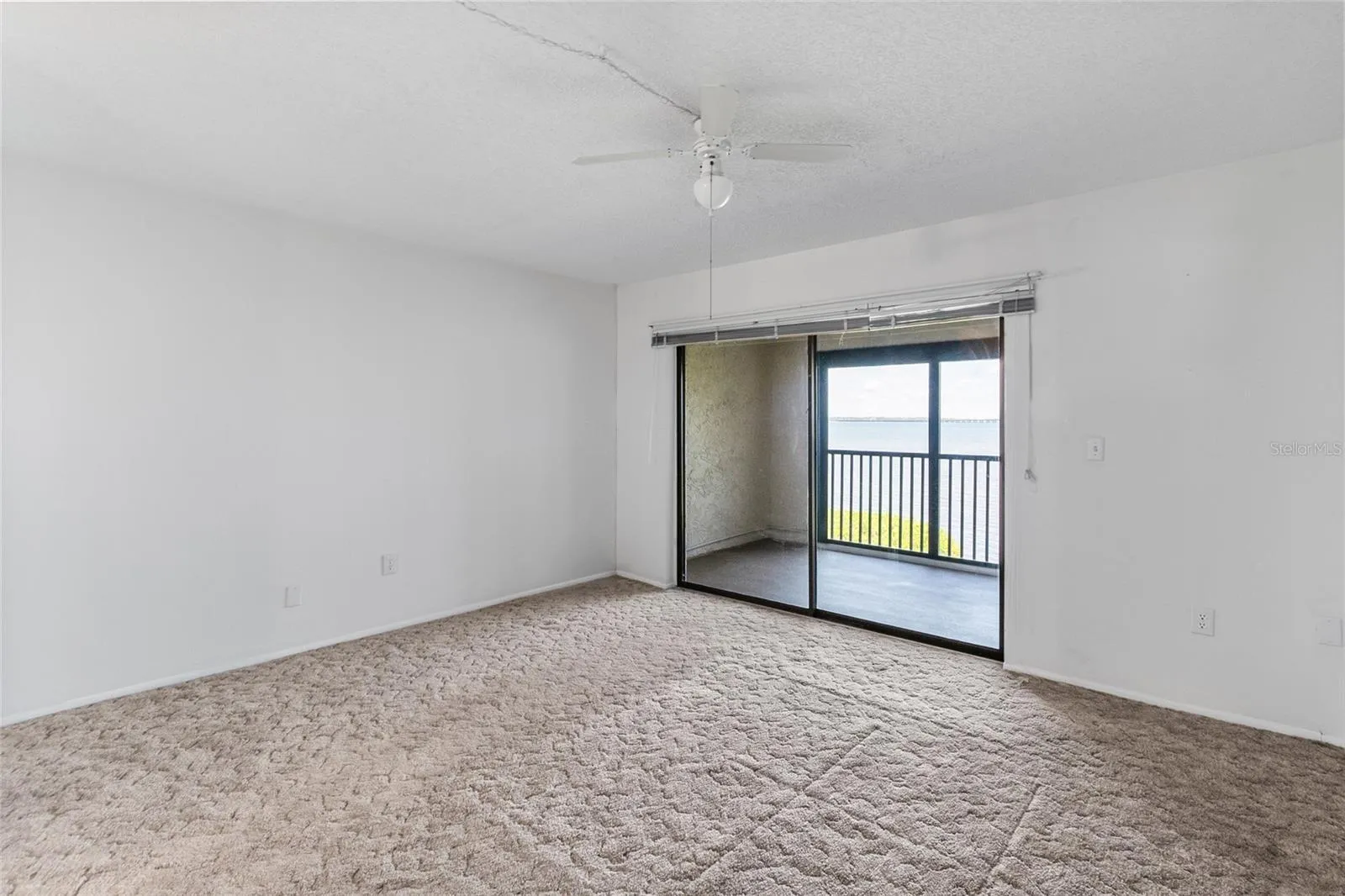 Primary bedroom - looking towards the private balcony with panoramic water views.