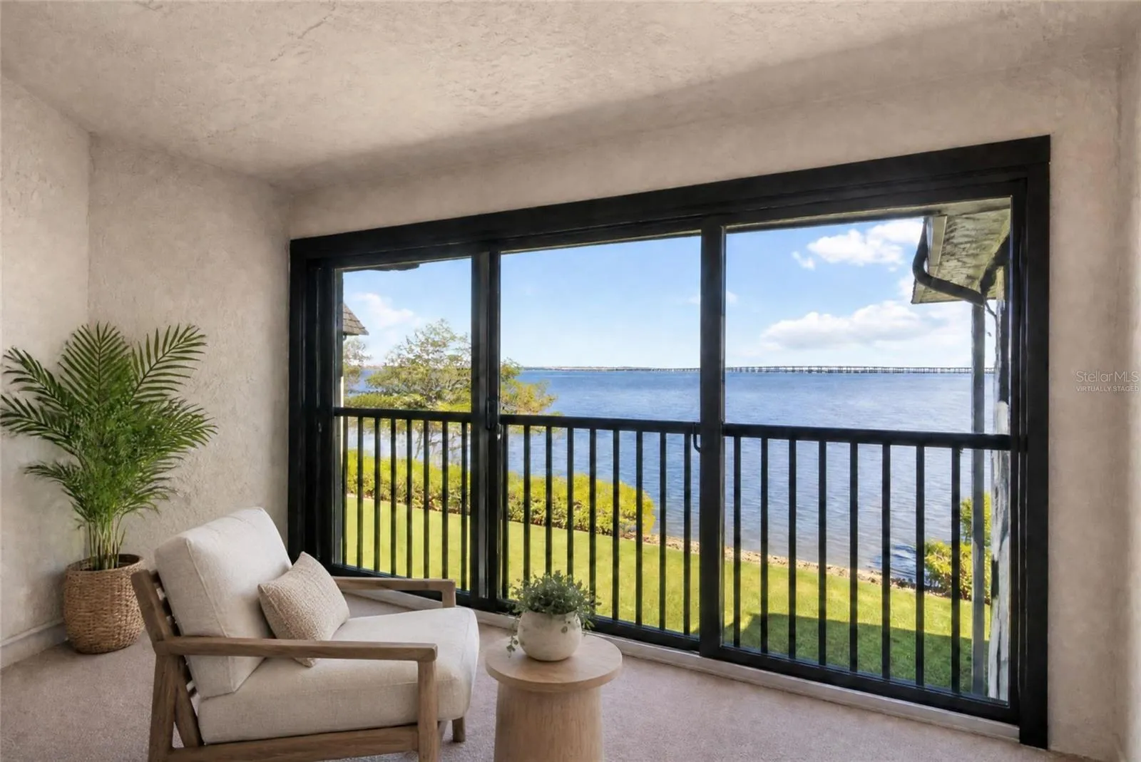 Virtually staged - primary bedroom balcony with water view