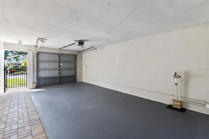 Open concept garage with door, opener and hookup for water softner
