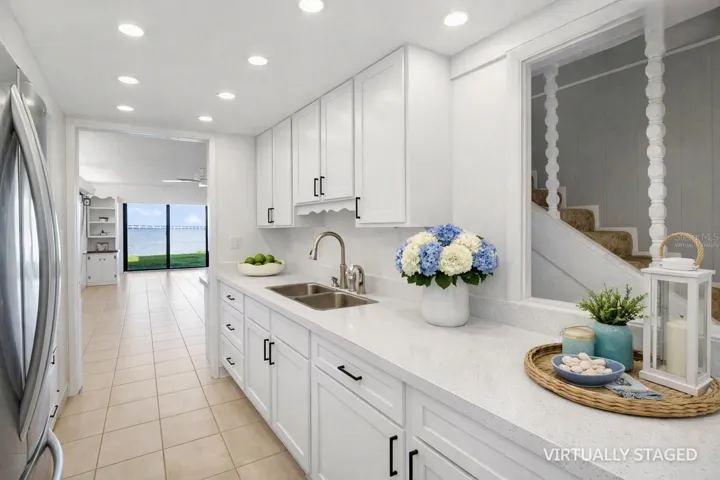 Virtually staged kitchem -to help envision recessed lighting, quart counter tops and white cabinets