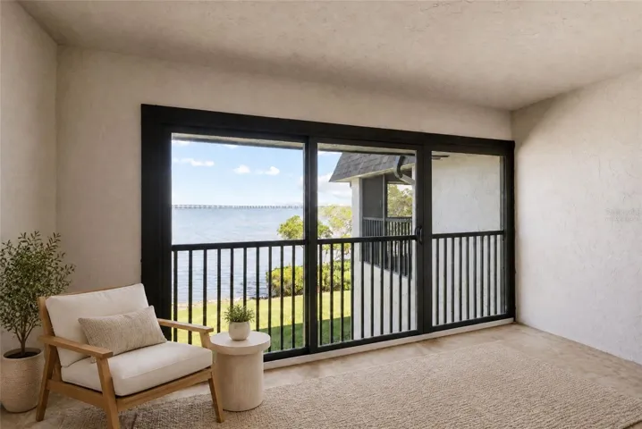 Virtually staged balcony off primary bedroom with panoramic water views