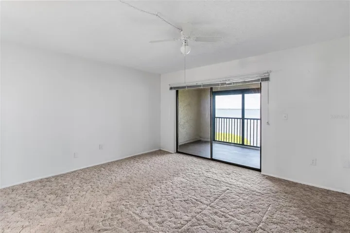 Primary bedroom - looking towards the private balcony with panoramic water views.