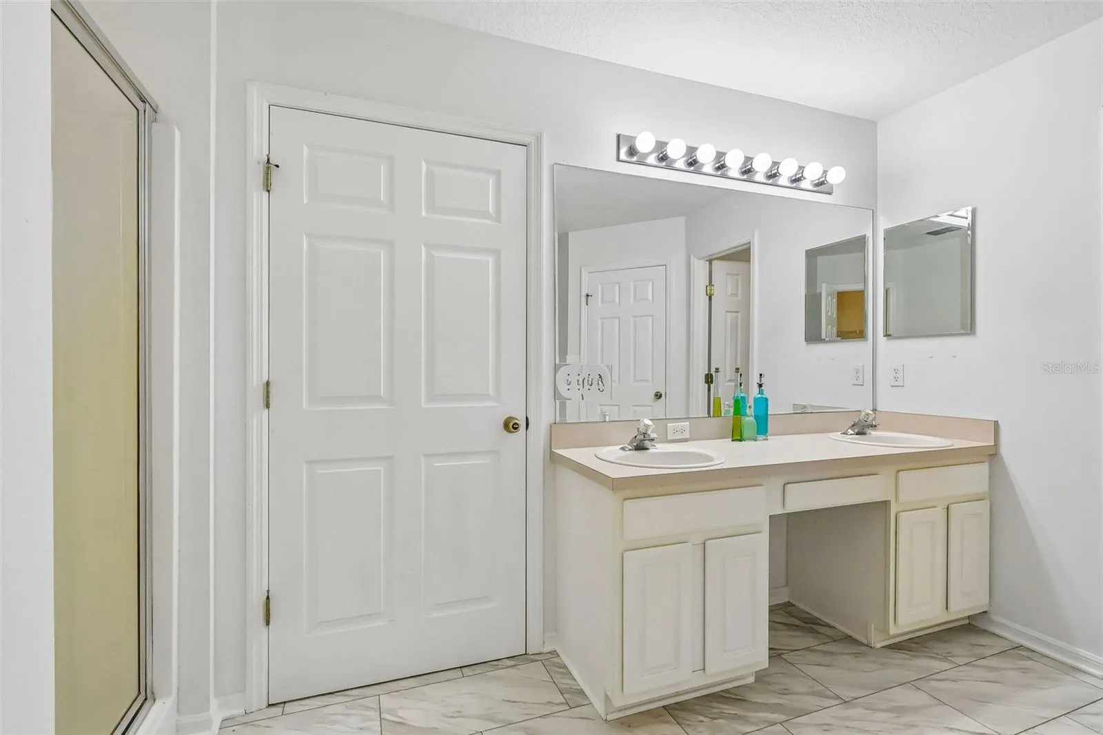 Master bath with water closet, stand up shower, soaking tub, and two walk-in closets.