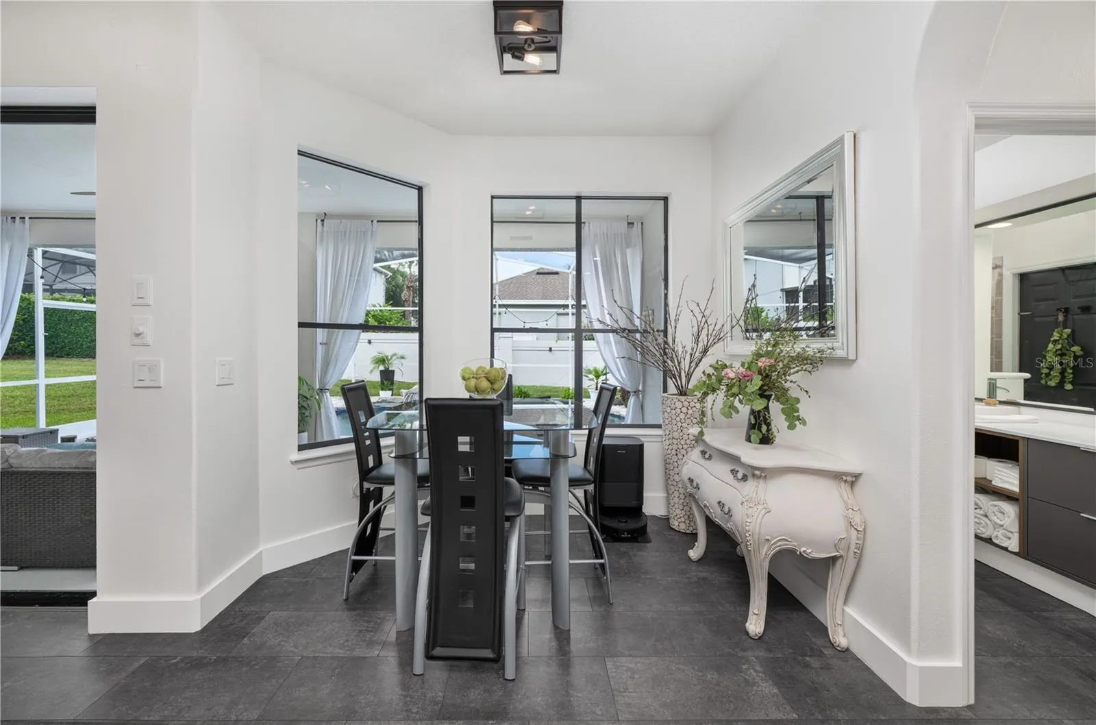 Bright and inviting breakfast nook with a picturesque view of the pool.