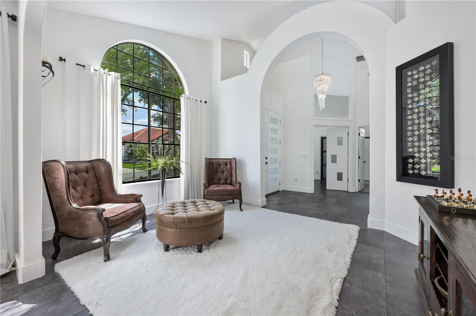 This formal living room is a standout feature of the home, providing an elegant space for relaxation and the perfect backdrop for a holiday tree.
