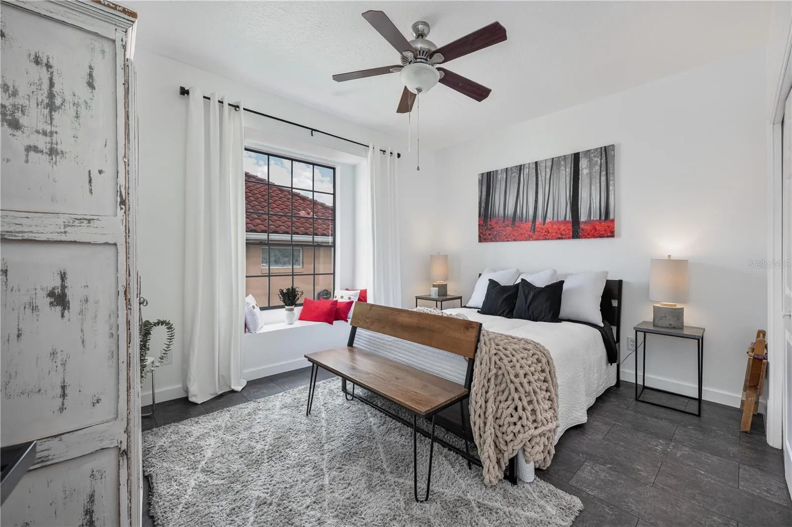 The charming window seat in this secondary bedroom is the perfect spot to read a book.